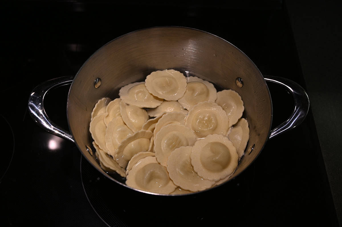 Image of a pot of drained ravioli sitting on a stovetop.