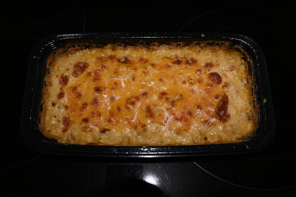 Top down image of a container of bacon macaroni and cheese after being baked.