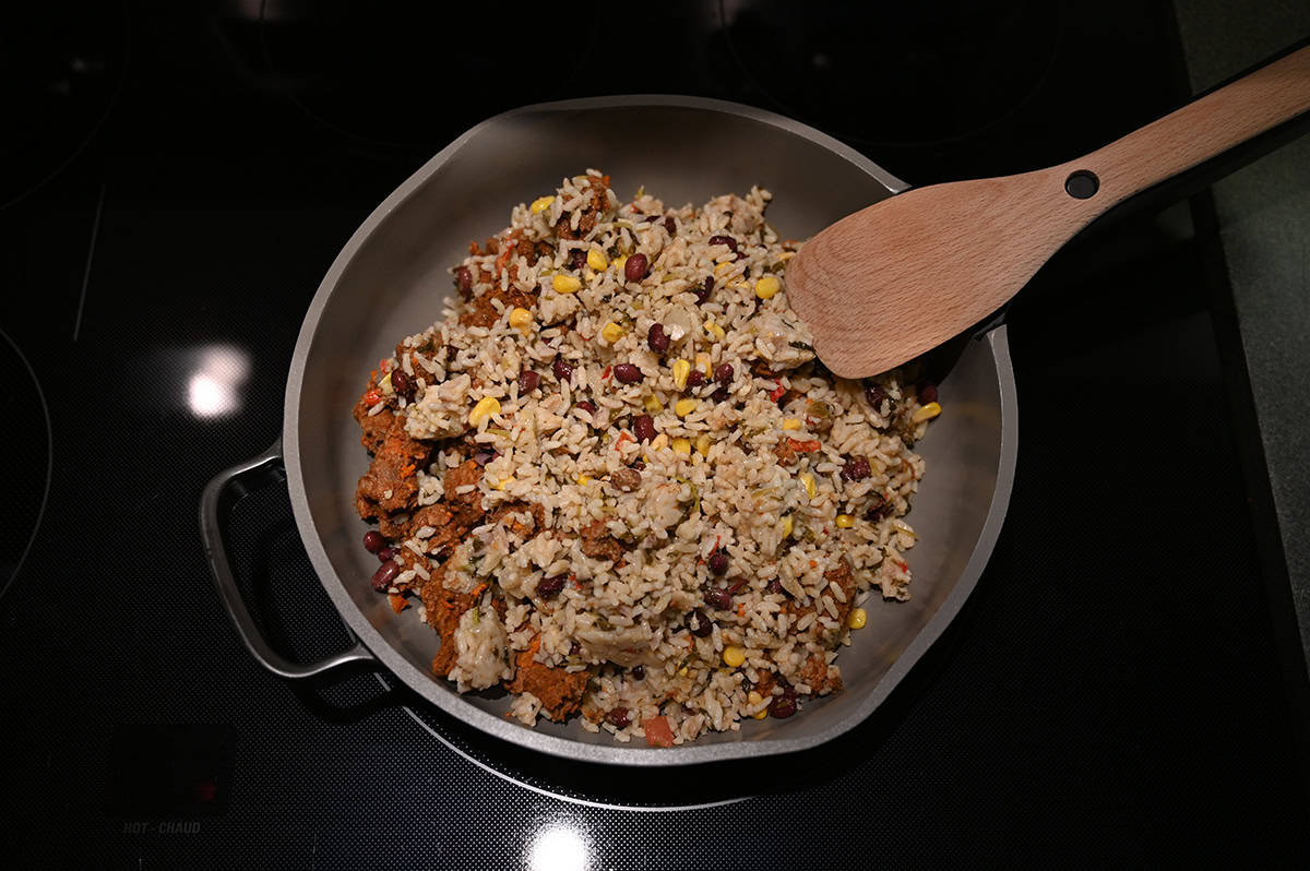 Image of the Costco Kirkland Signature Beef Birria Burrito Bowl meal in a pan on the stove prior to heating it.