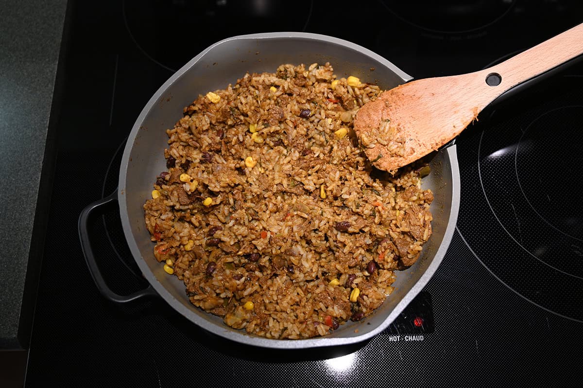 Image of the Costco Kirkland Signature Beef Birria Burrito Bowl meal in a pan on the stove after heating it.