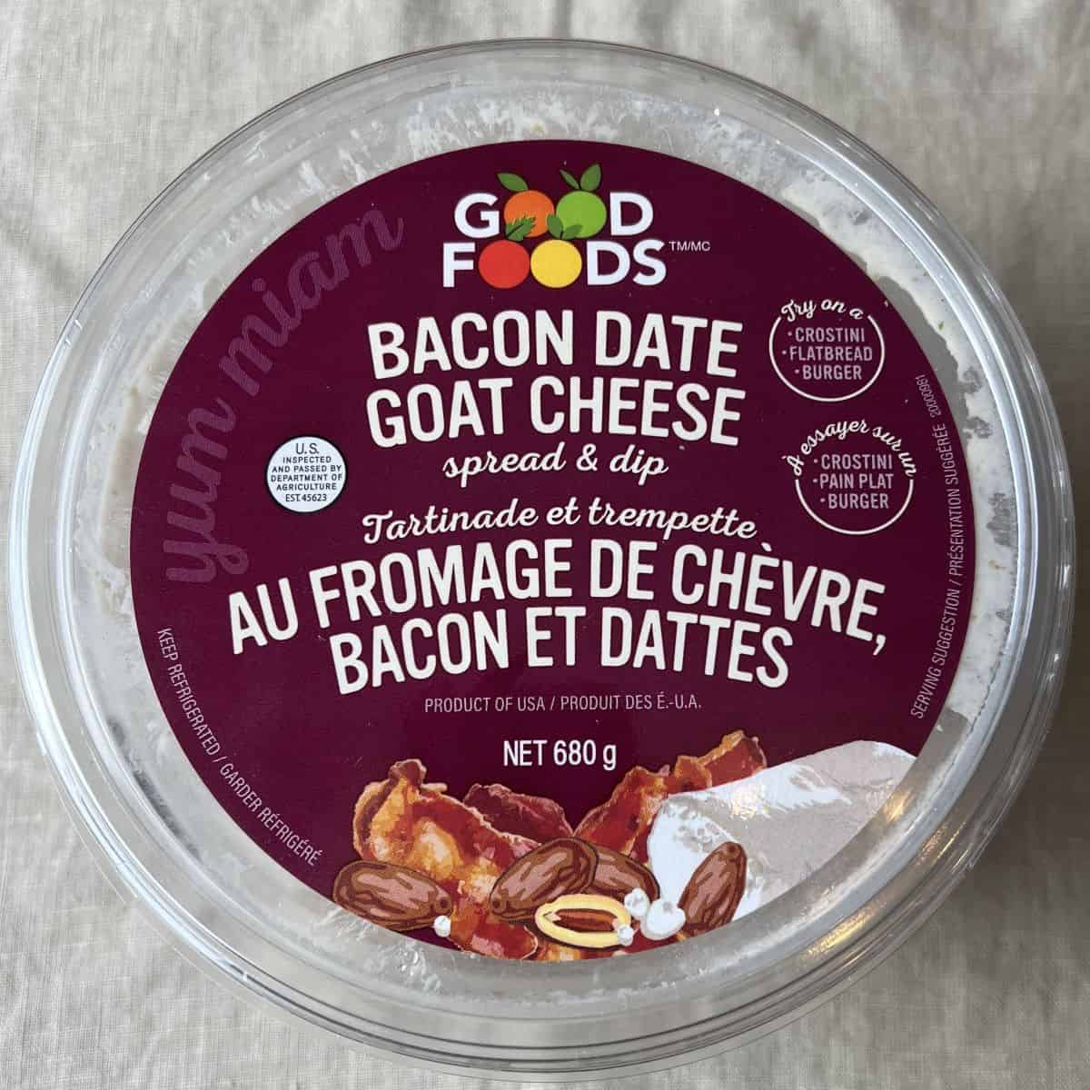 Image of the Good Foods Bacon Date Goat Cheese Spread & Dip container top showing the weight of the container and that it's a product of USA. 