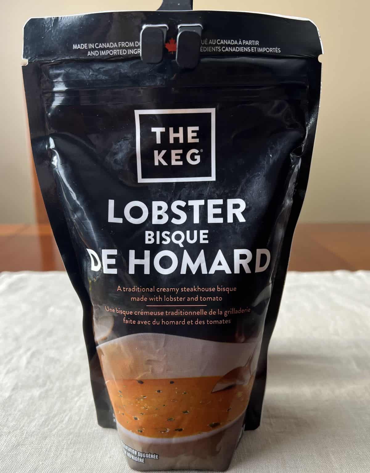 Image of the Costco The Keg Lobster Bisque package sitting on a table unopened.