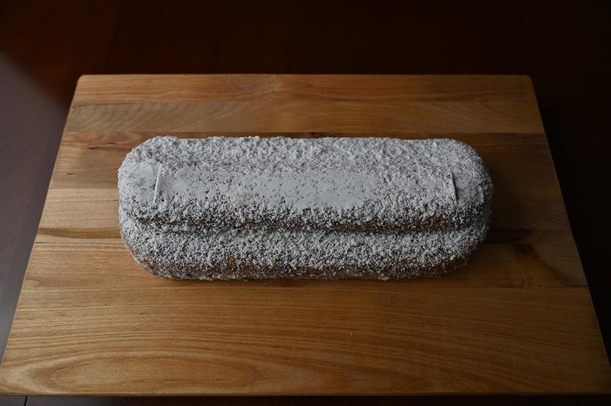 Image of a whole Stollen served on a wood cutting board.