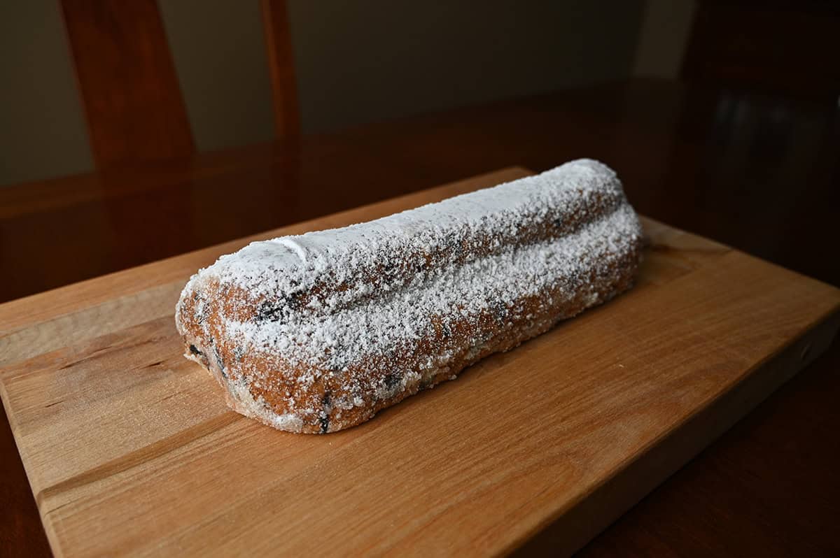 Image of a Holiday Stollen served whole on a wood cutting board.