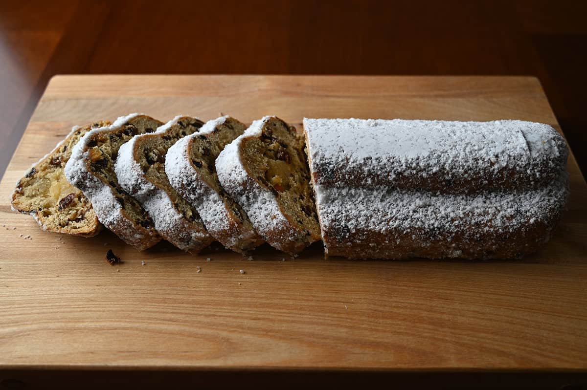 Image of the Holiday Stollen sliced and served on a wood cutting board.