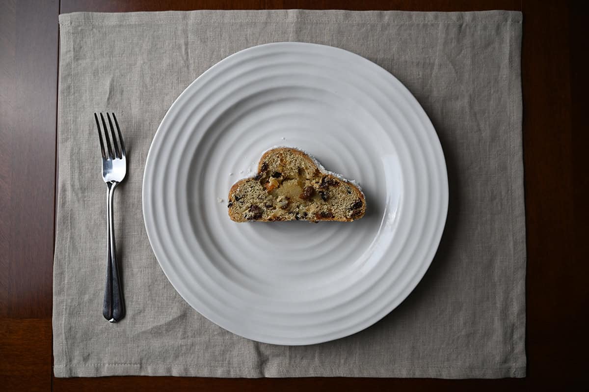 Image of one slice of Stollen served on a white plate.