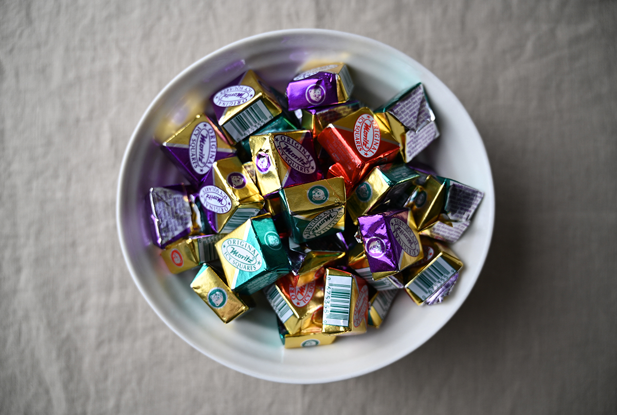 Image of a white bowl filled with wrapped icy squares.