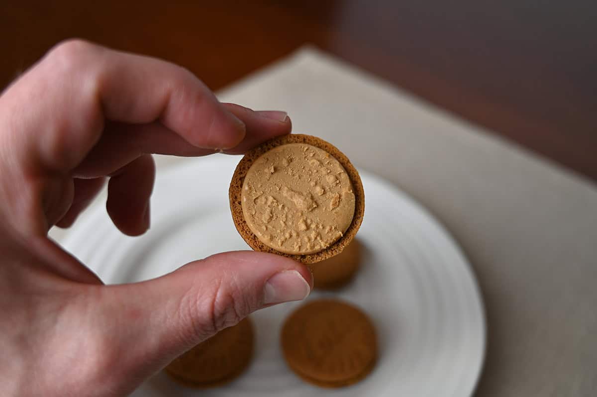 Image of a sandwich cookie pulled apart so you can see the cream center in the middle.