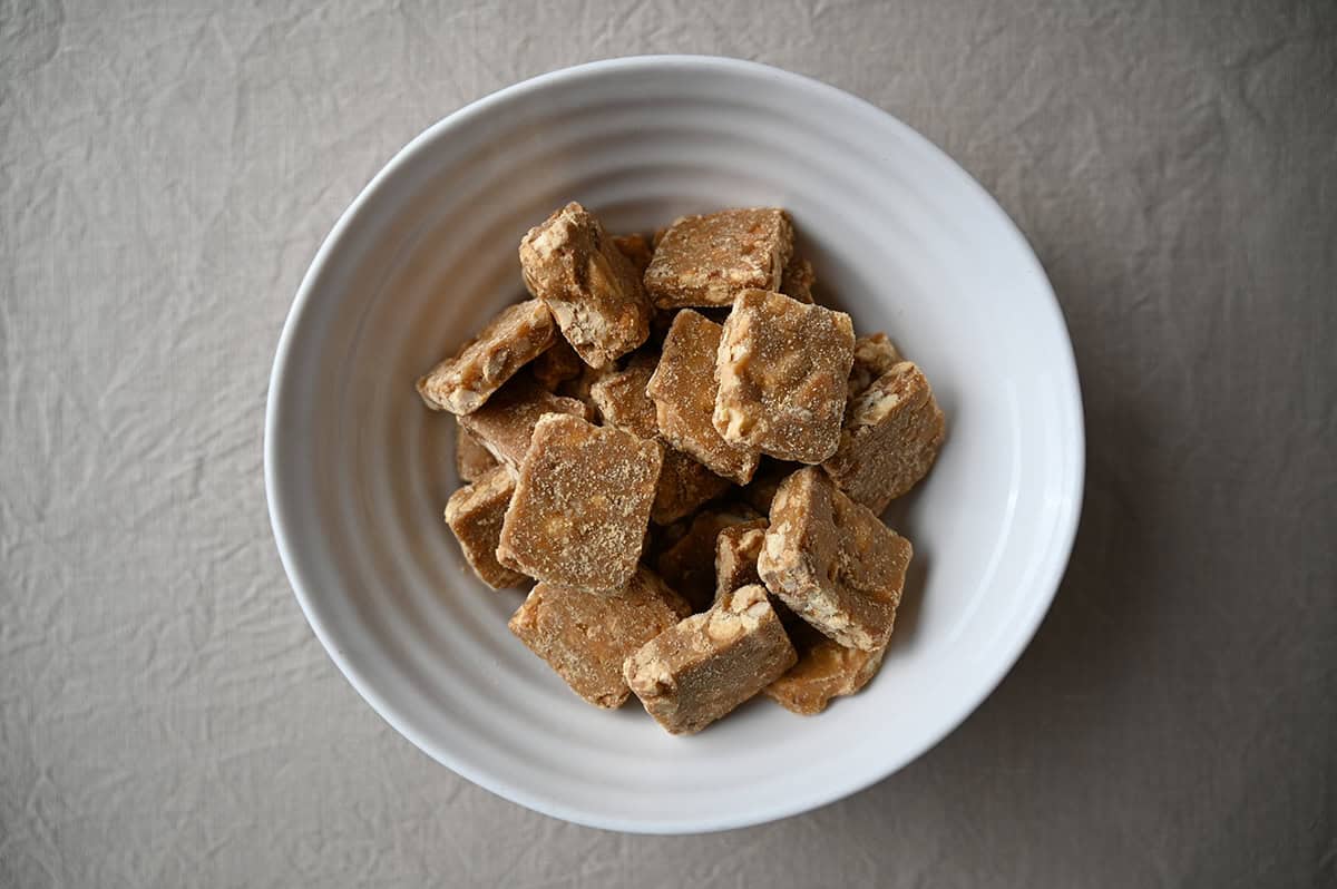 Image of a bowl full of peanut brittle bites.