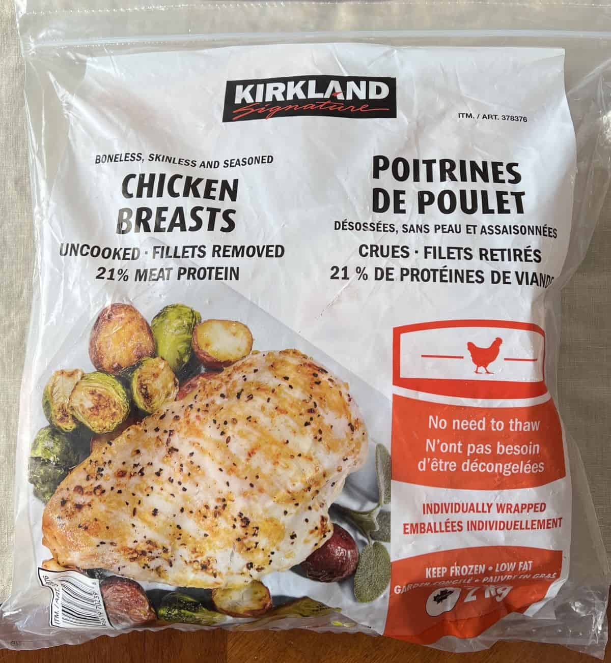 Image of the Costco Kirkland Signature Frozen Chicken Breasts bag laying on a table unopened.