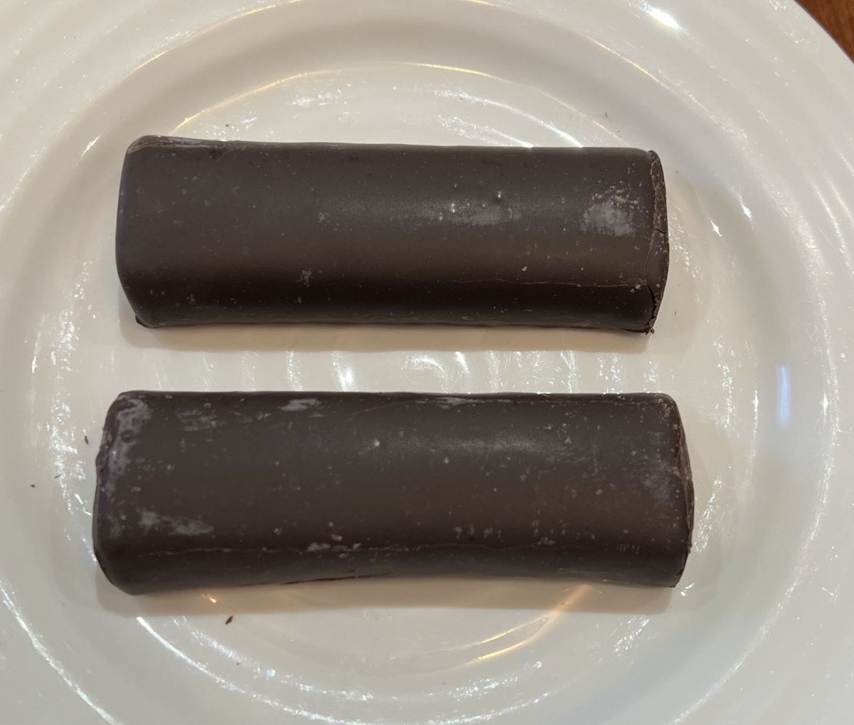 Top down image of two Built Puff Protein Bars unwrapped and served on a white plate. 