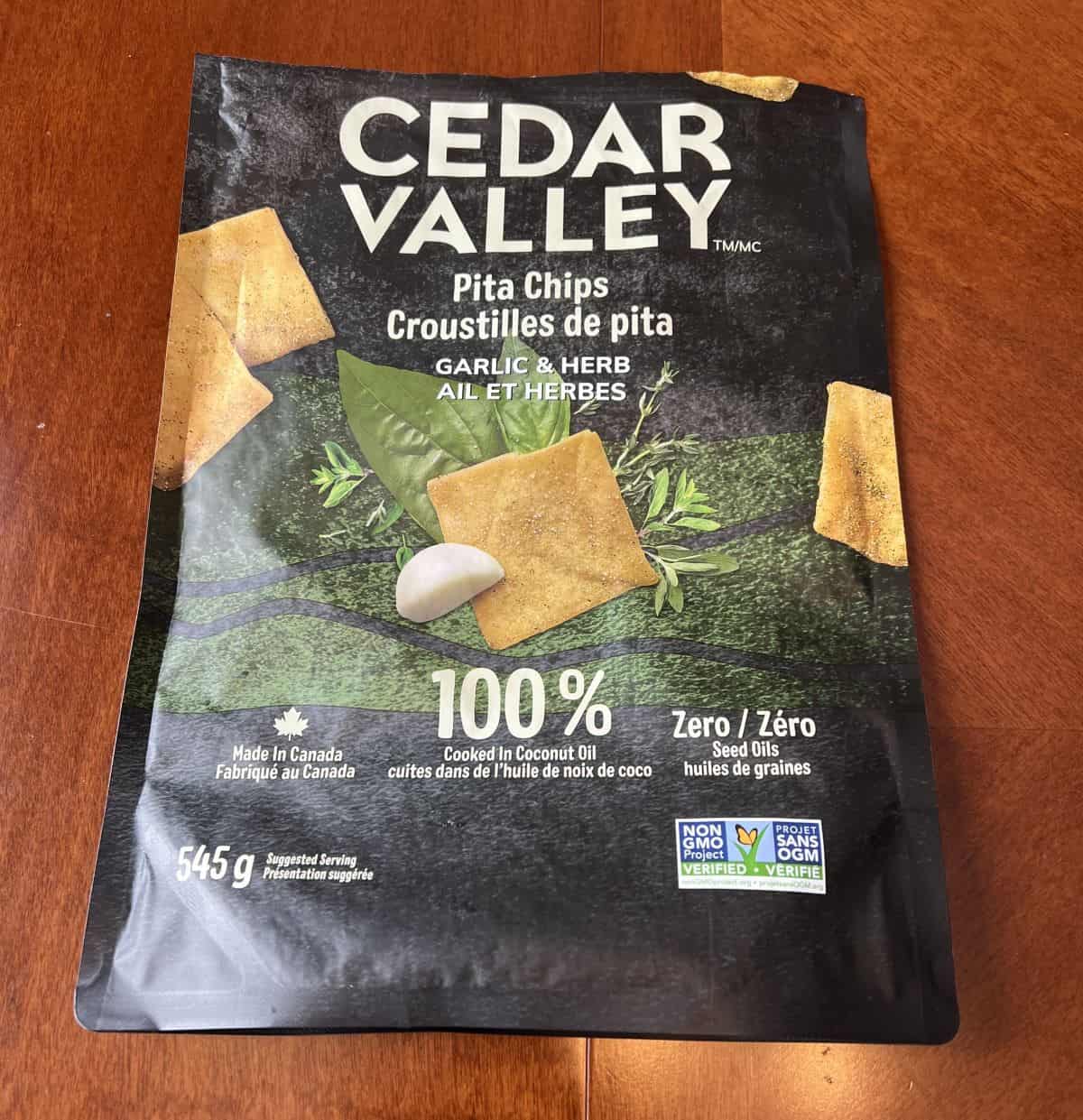 Closeup image of the bag of Cedar Valley Pita Chips showing the size of the bag, made in Canada and cooked in coconut oil.