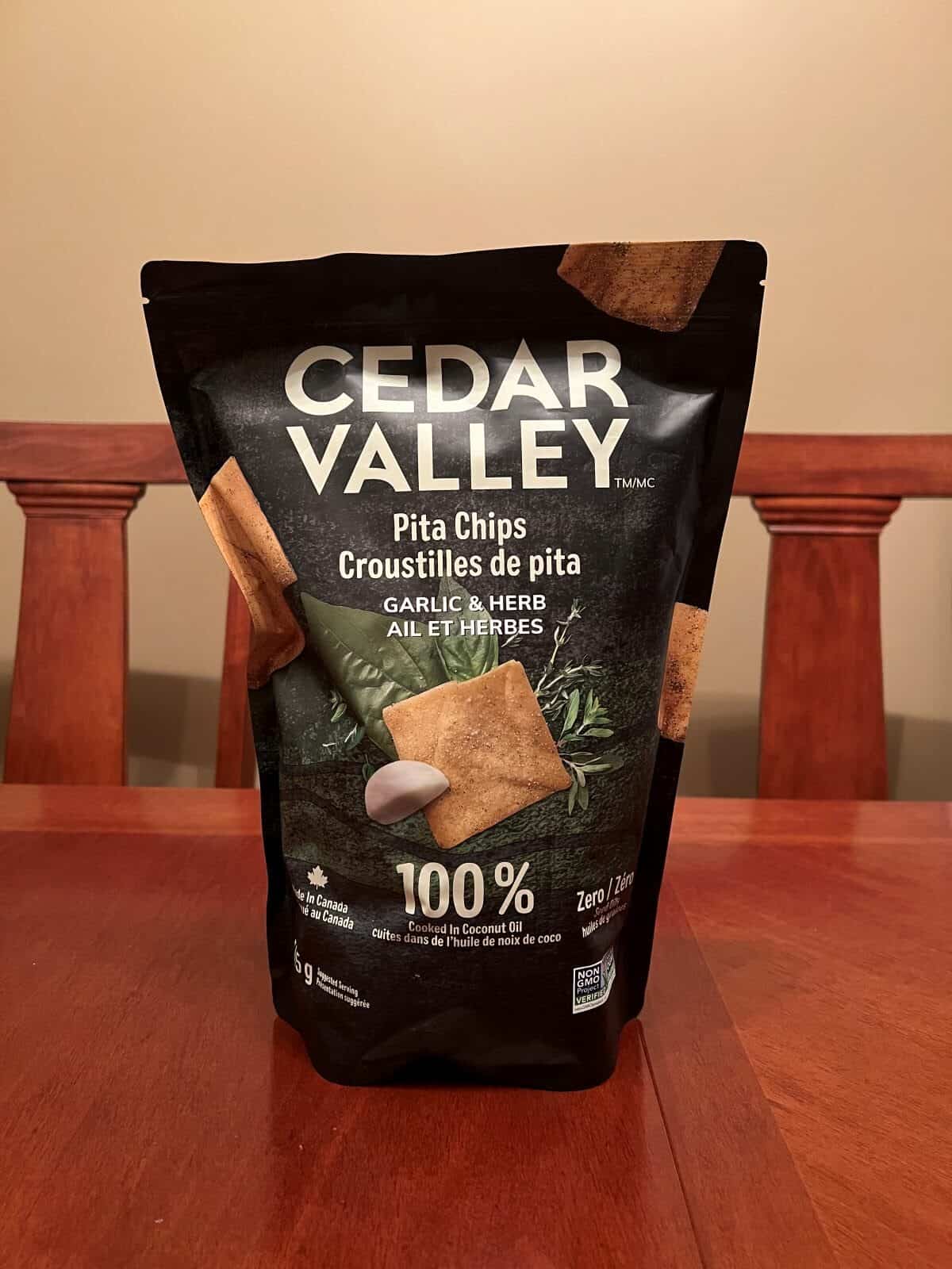 Costco Cedar Valley Pita Chips bag sitting on a table unopened. 