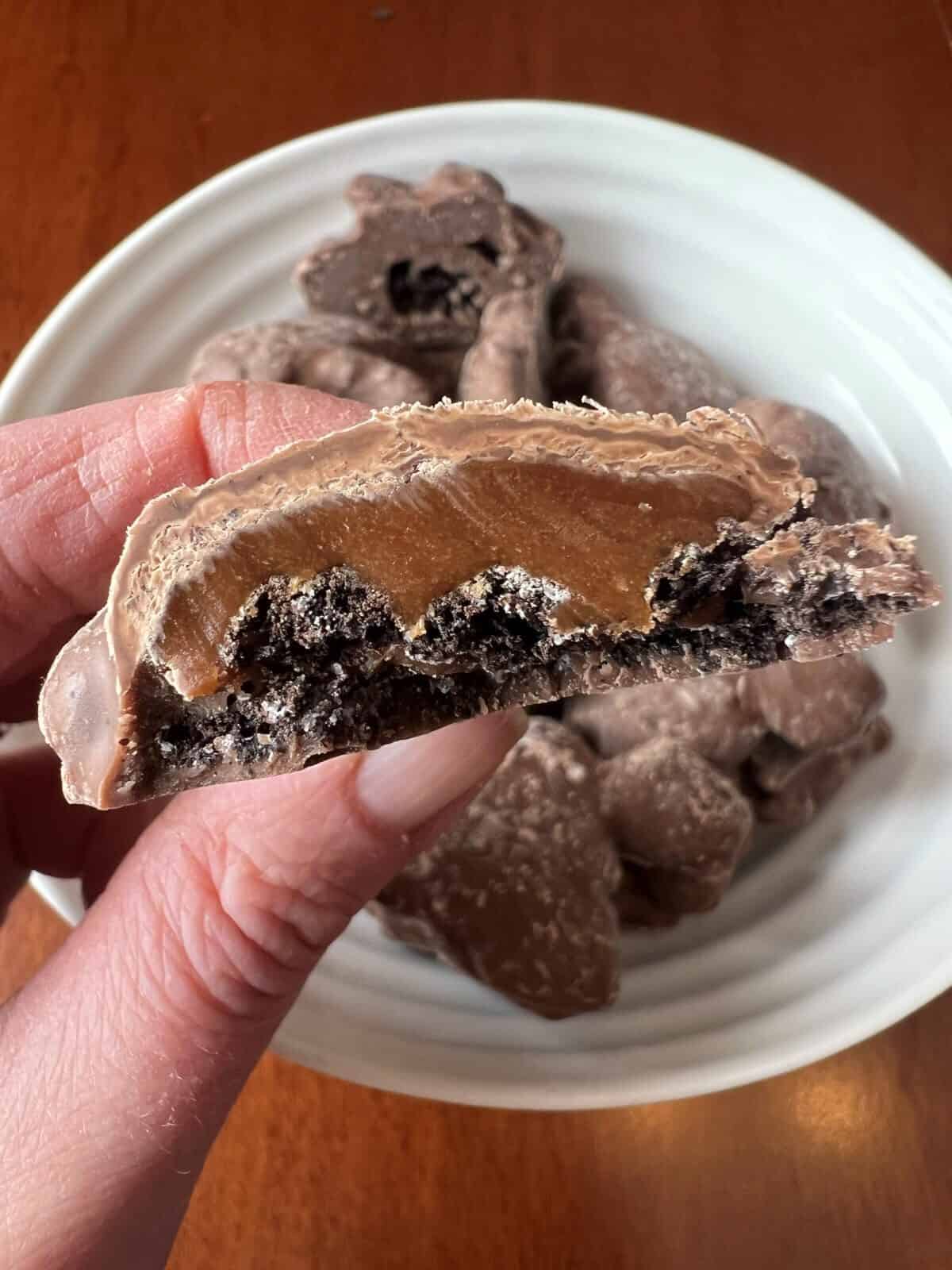 Image of the Costco Copper Kettle Candy Co. Chocolate Cookie Biscuit Cluster close to the camera with a bite taken out of it so you can see the center.