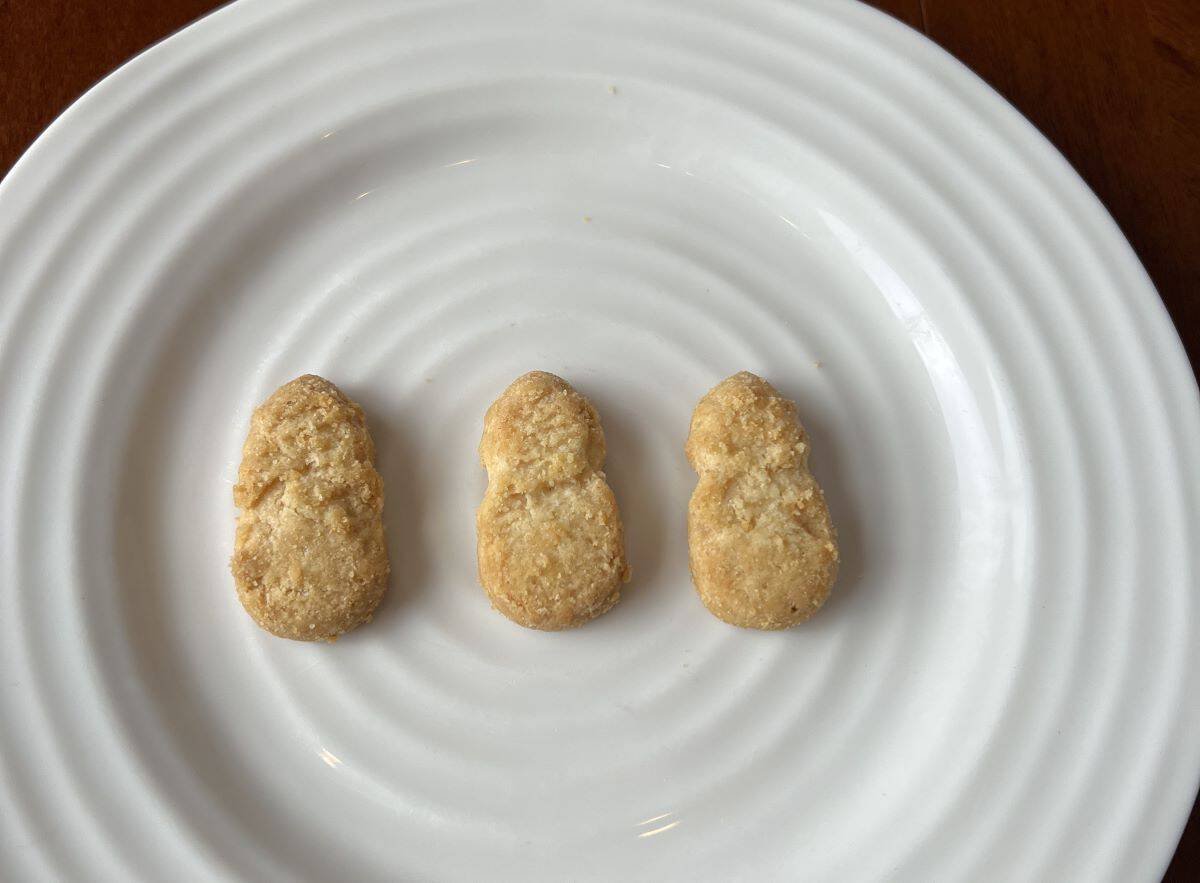 Three pineapple cookies served on a white plate.