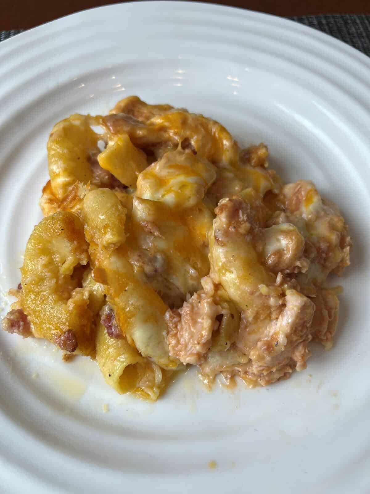 Closeup image of a plate of cooked Chicken and Bacon Mac and Cheese. 