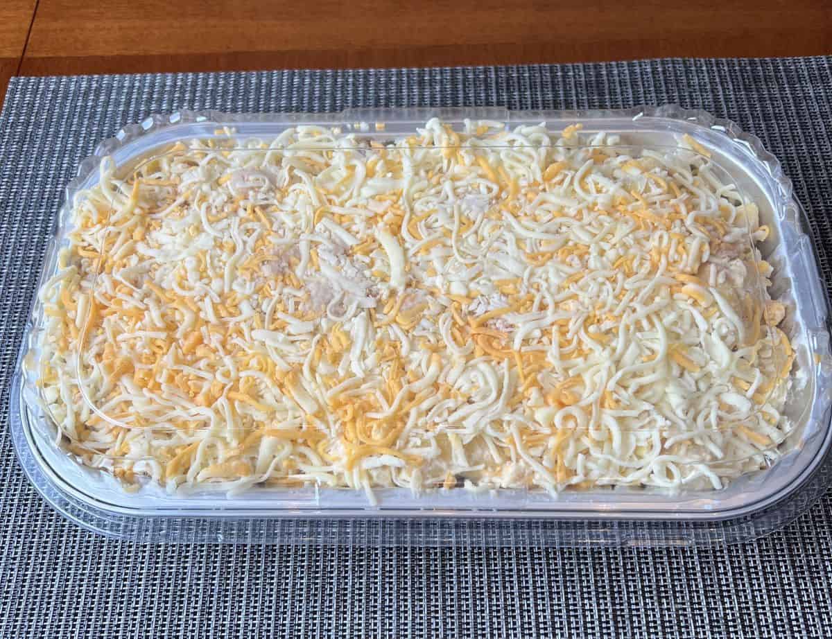 Image of the Chicken and Bacon Mac and Cheese tray sitting on a table showing what the top of the meal looks like unbaked.