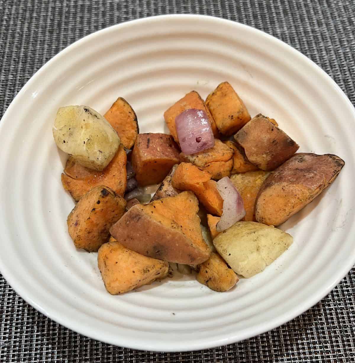 Top down image of a bowl of root vegetables. 