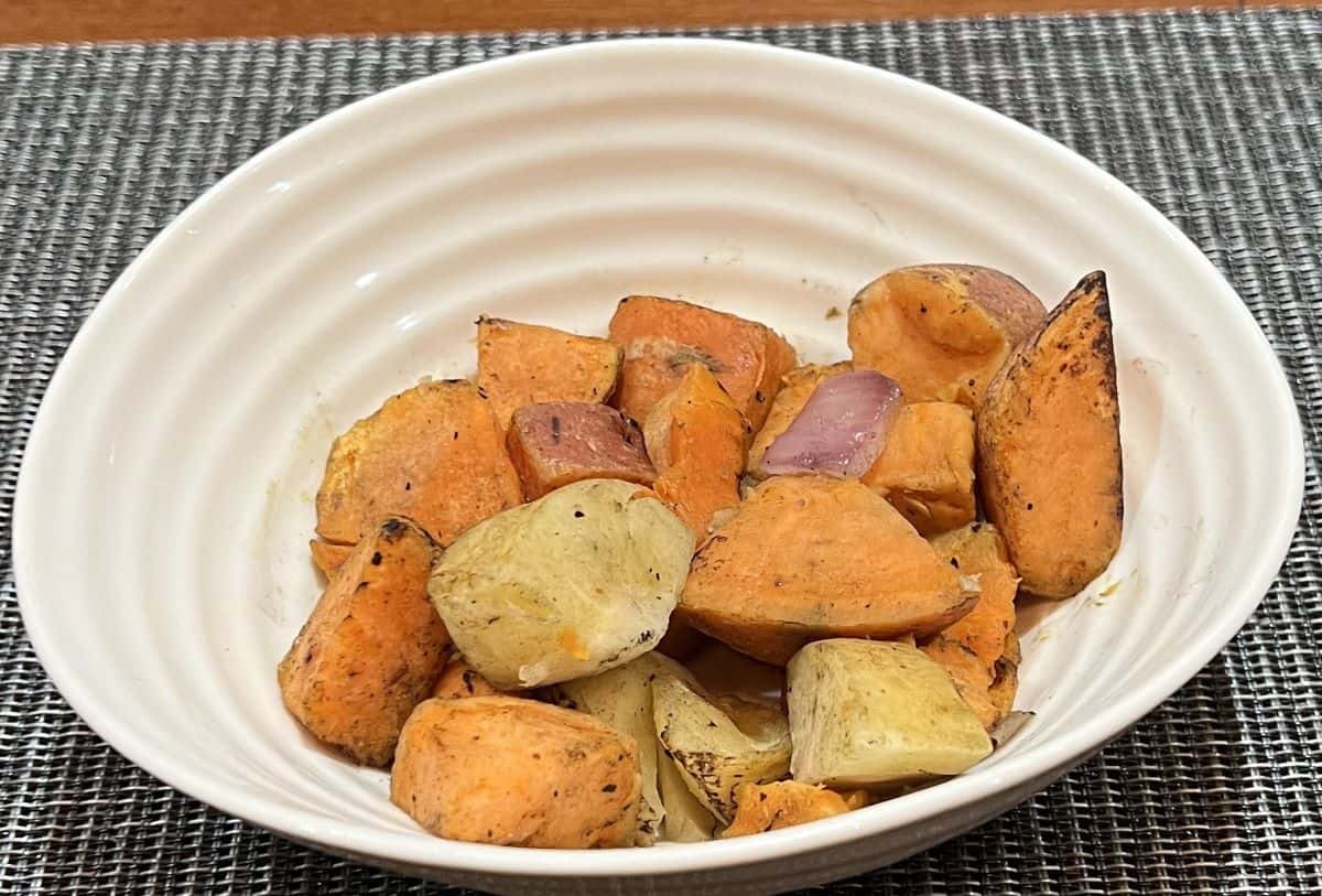 Sideview image of a bowl of roasted root vegetables.