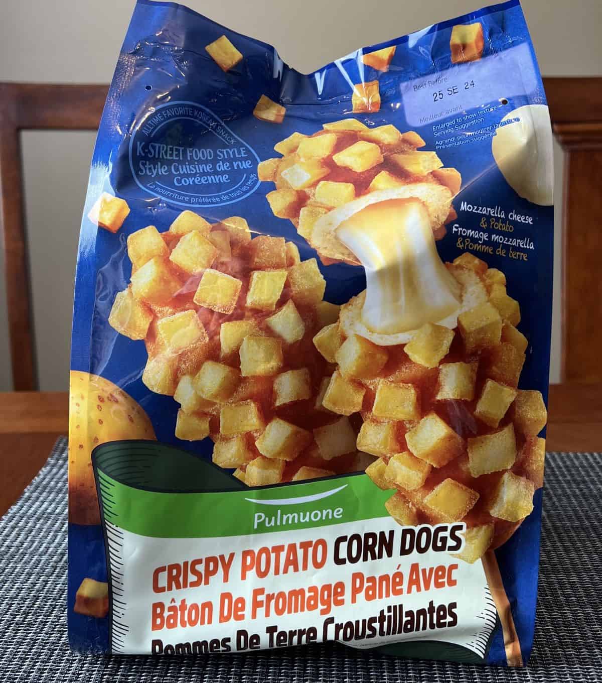 Costco Pulmuone Crispy Potato Corn Dogs bag sitting on a table unopened.