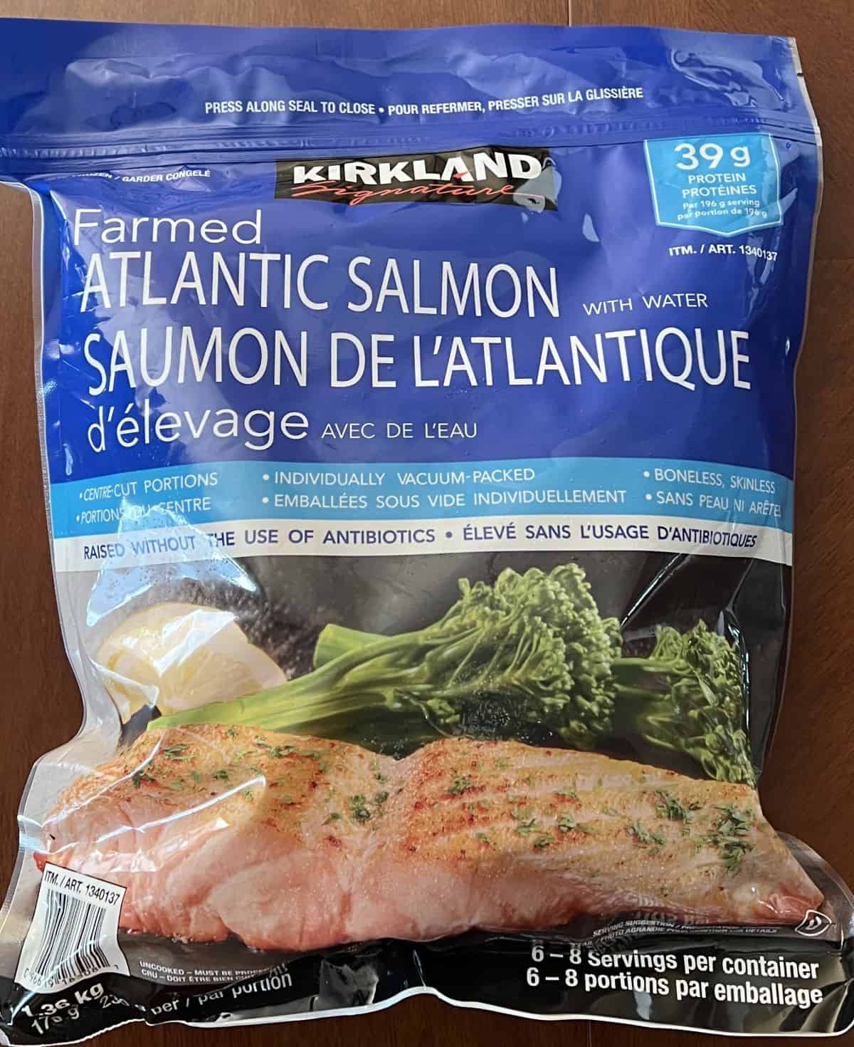 Image of the Costco Kirkland Signature Farmed Atlantic Salmon bag sitting on a table unopened.