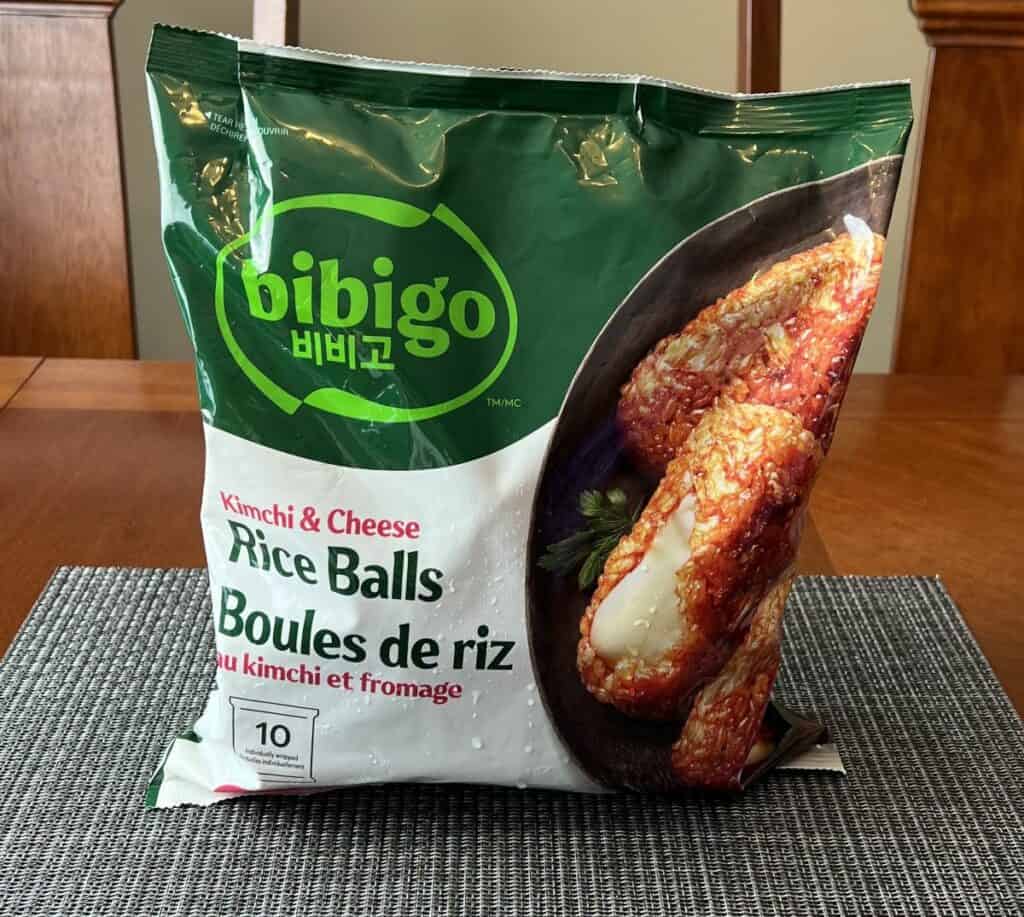 Costco Bibigo Kimchi & Cheese Rice Balls bag sitting on a table unopened. 