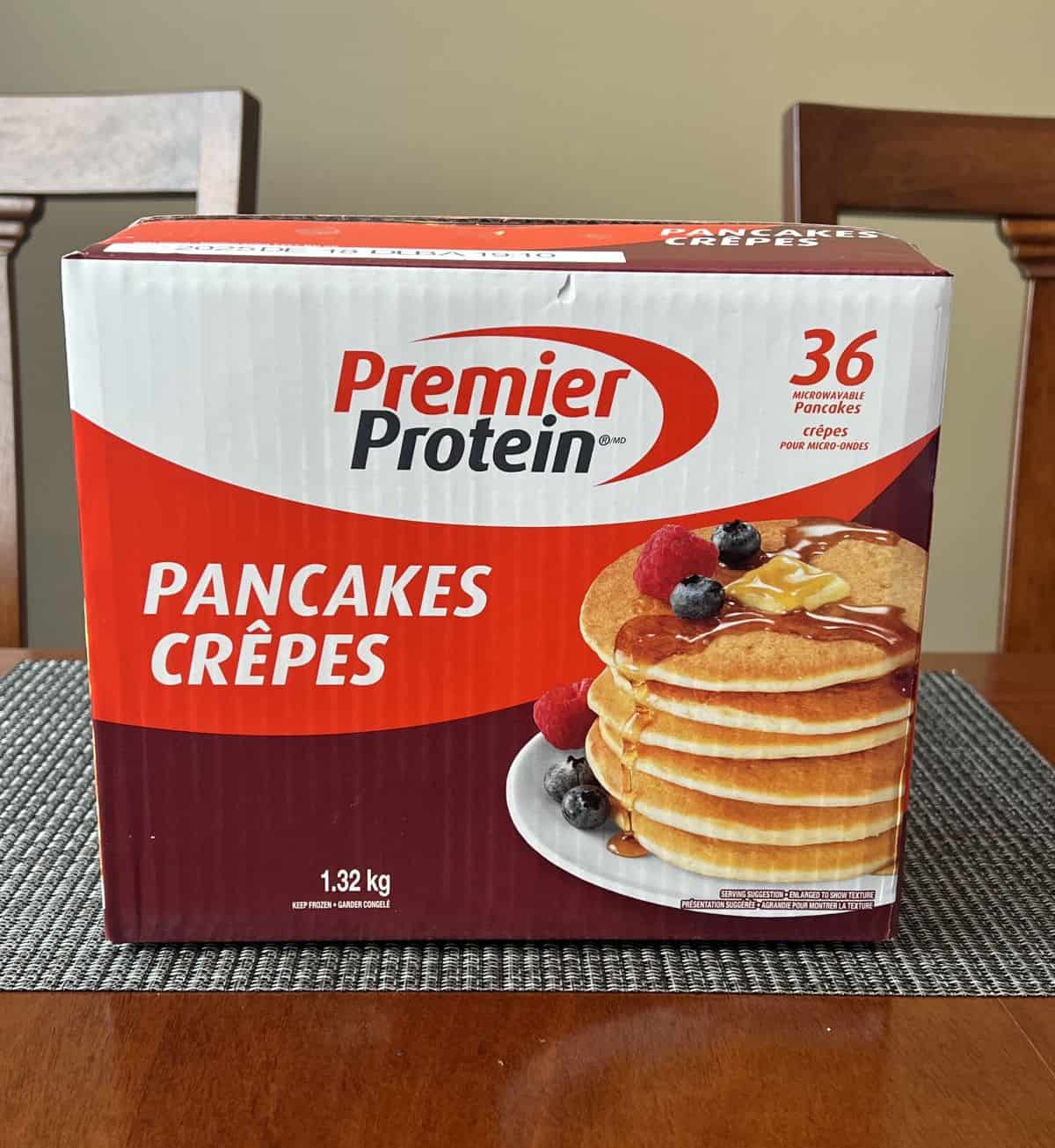 Image of the box of Premier Protein Pancakes sitting on a table unopened.