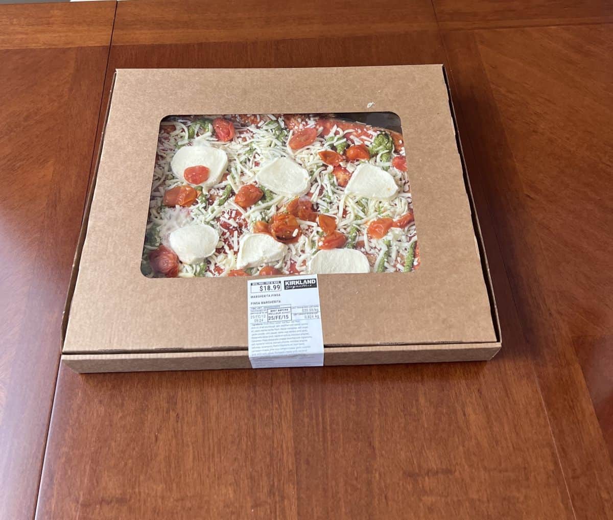 Image of the Costco Kirkland Signature Margherita Pinsa sitting in the box on a table unopened.