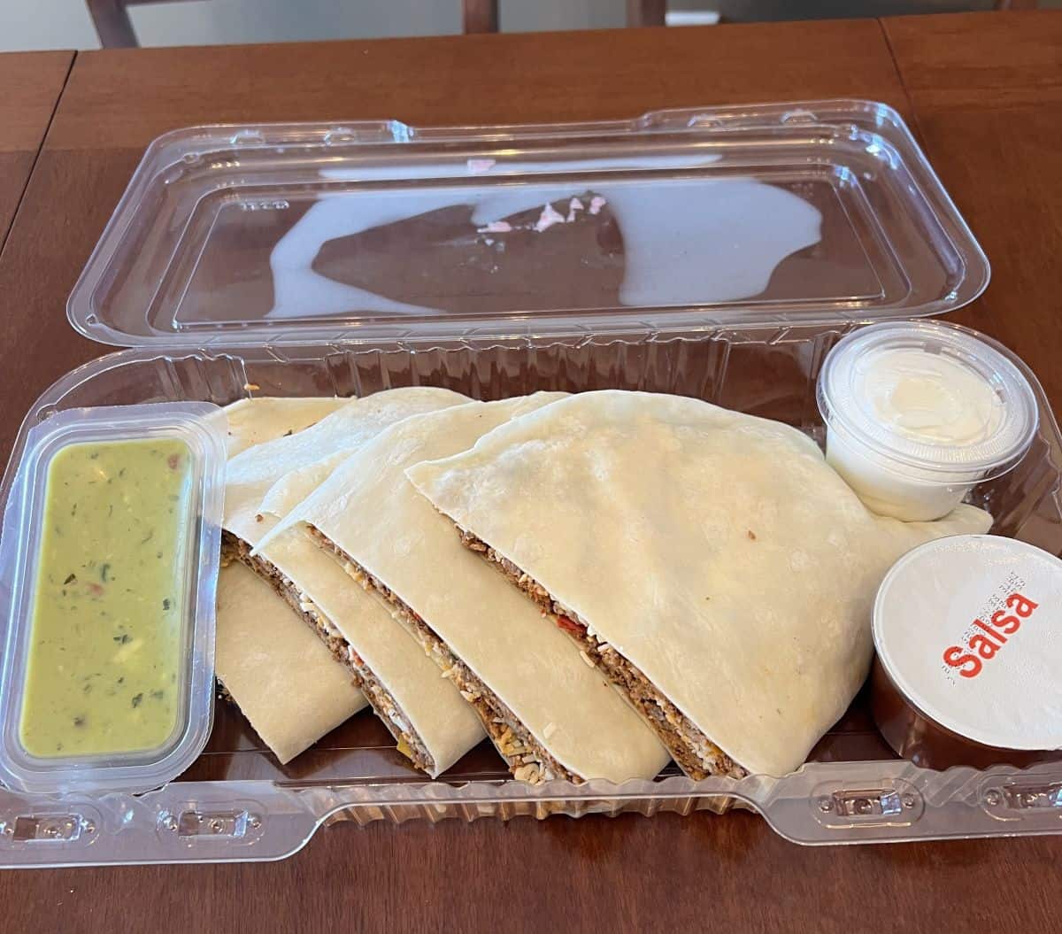 Image of the beef quesadillas meal sitting on a table with the lid off so you can see the contents inside.