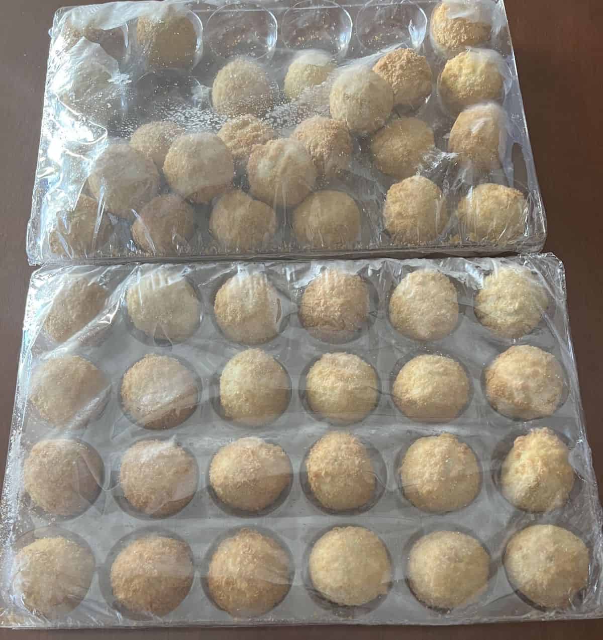 Image of two trays of 24 spinach and artichoke bites in plastic packaging unopened.