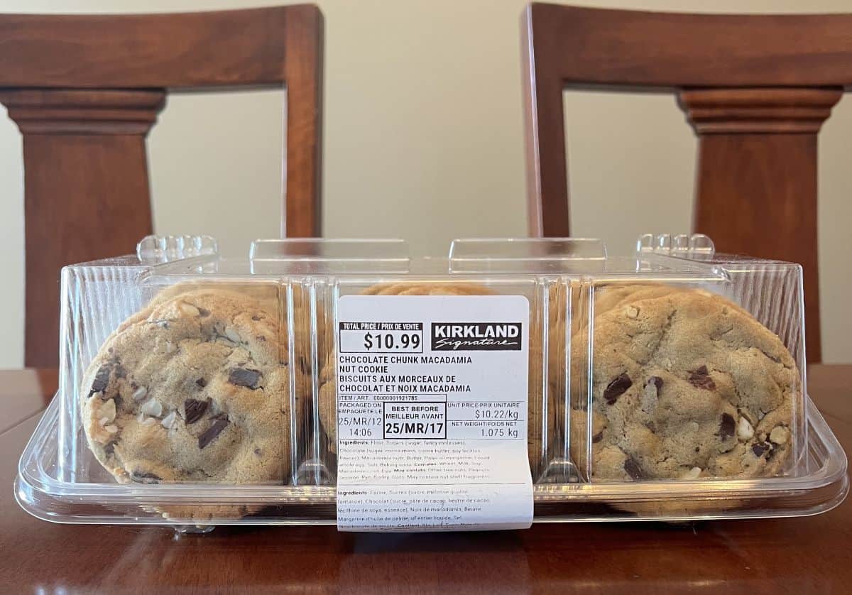 Image of the Costco Kirkland Signature Chocolate Chunk Macadamia Nut Cookies container sitting on a table unopened.