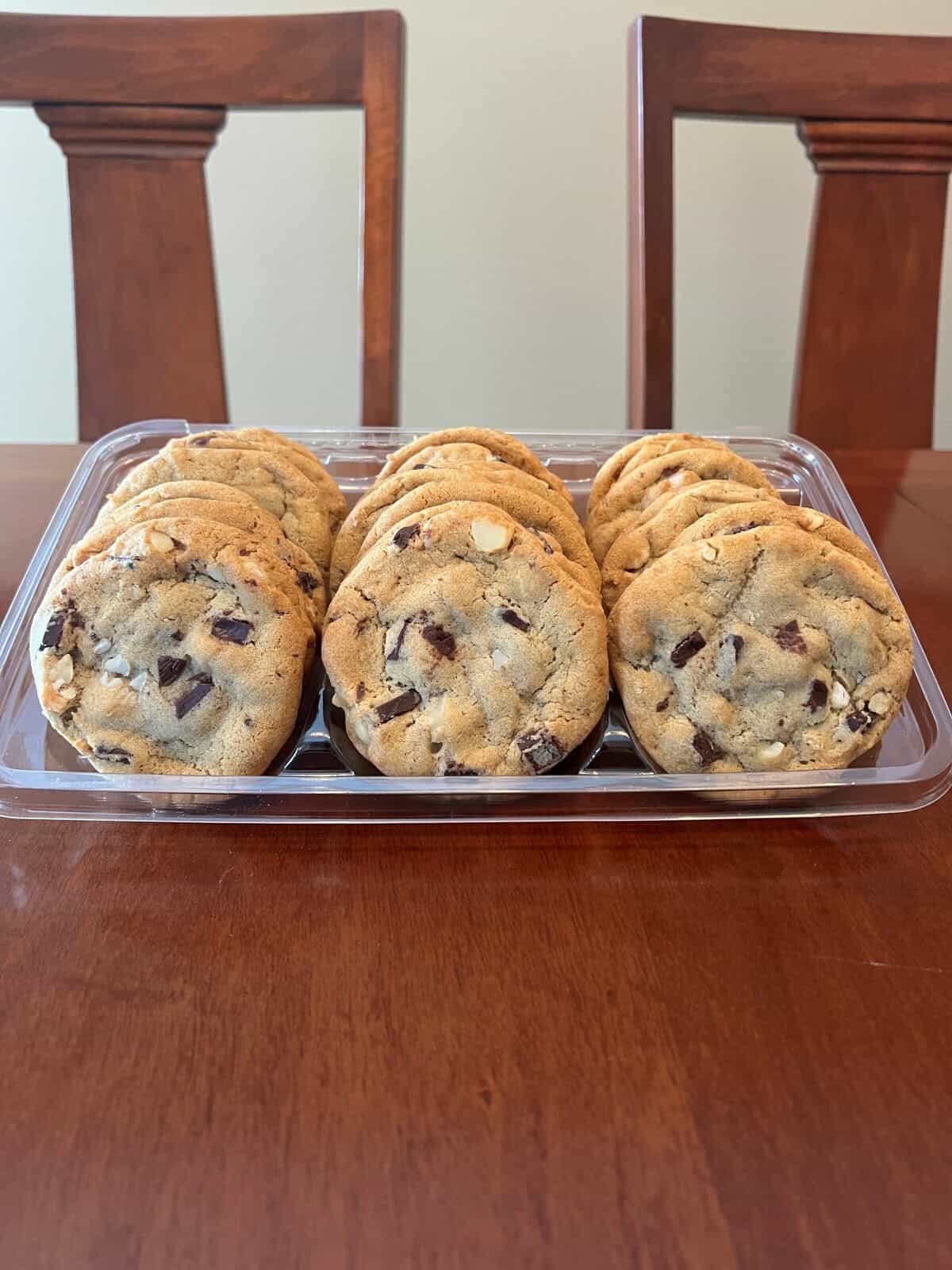 Image of the Costco Kirkland Signature Chocolate Chunk Macadamia Nut Cookies container sitting on a table opened.